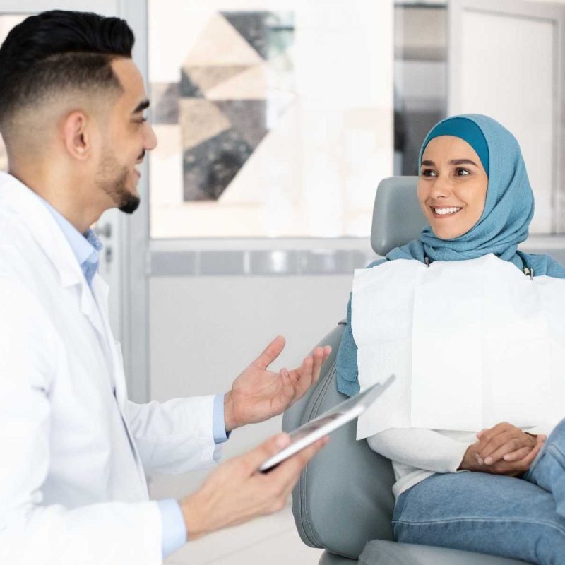 middle-eastern-dentist-and-muslim-female-patient-t-HQ6MLTN.jpg